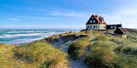 A cheerful red and yellow coastal home on the sand and greens in Skagen