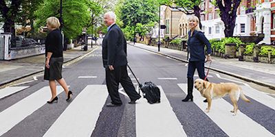 Tor Hagen, Karine Hagen, and her dog crossing an iconic road.