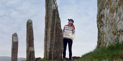 Karine Hagen with standing stones in Orkney Islands, Scotland